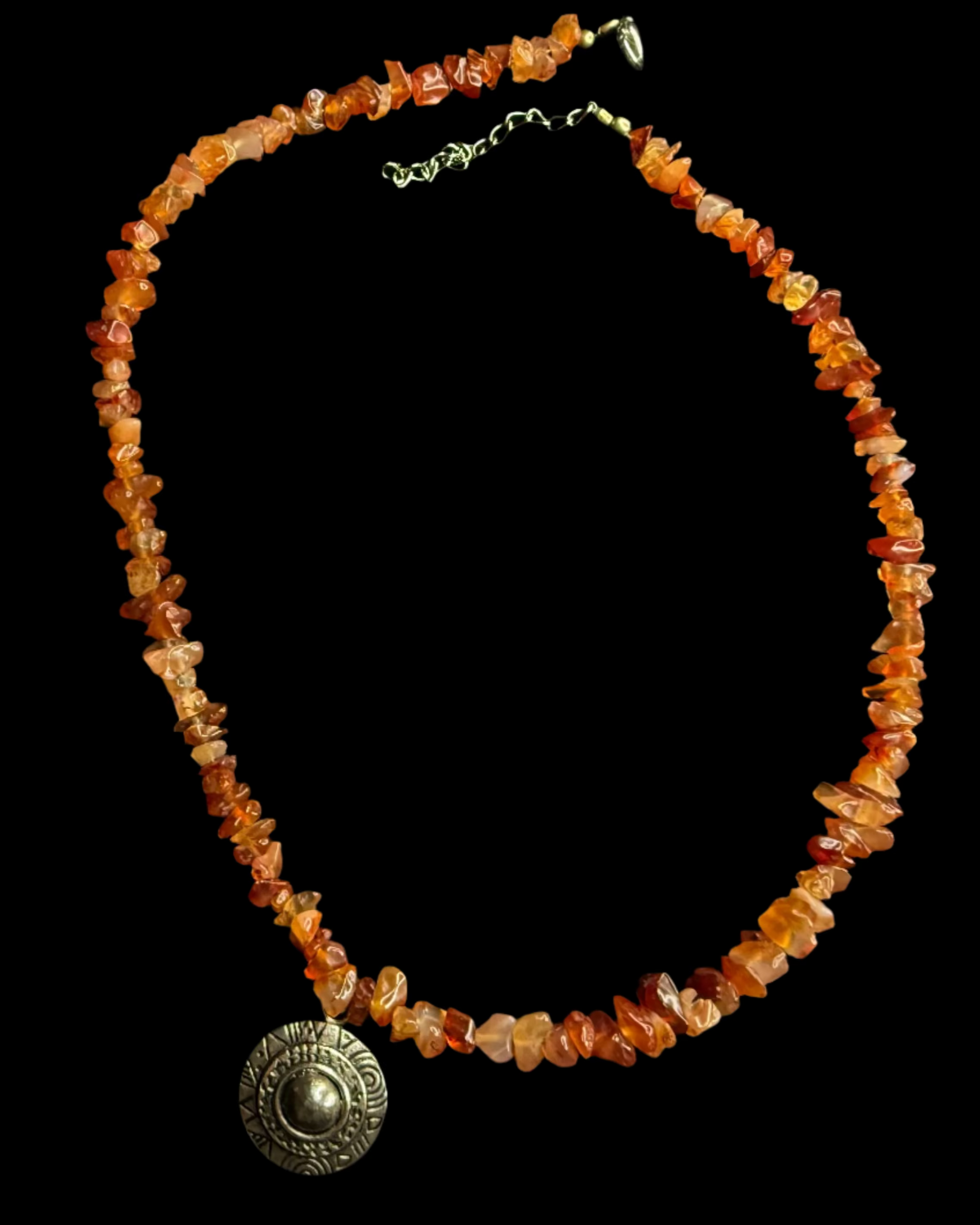 Necklace with orange beads and a silver pendant.